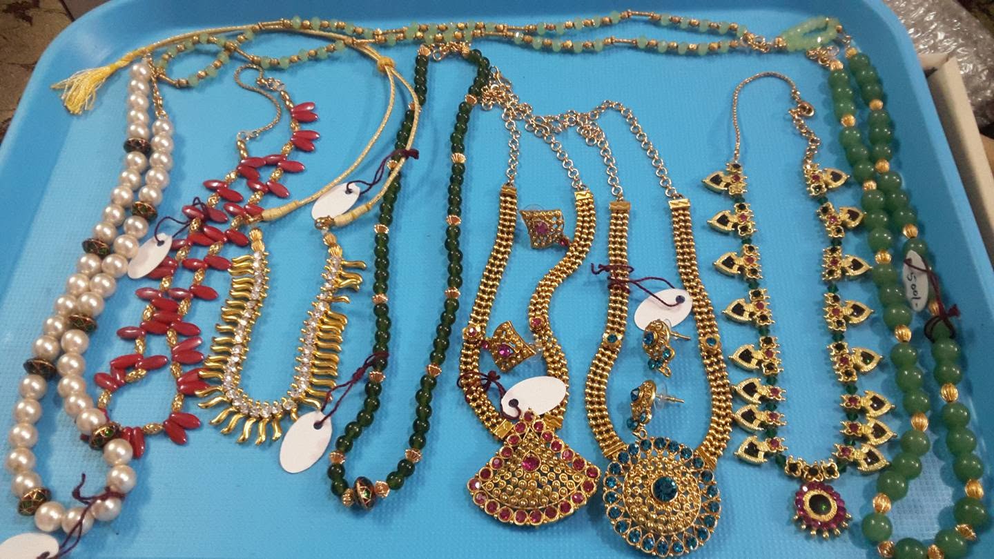 Handmade necklaces and jewellery arranged on a tray